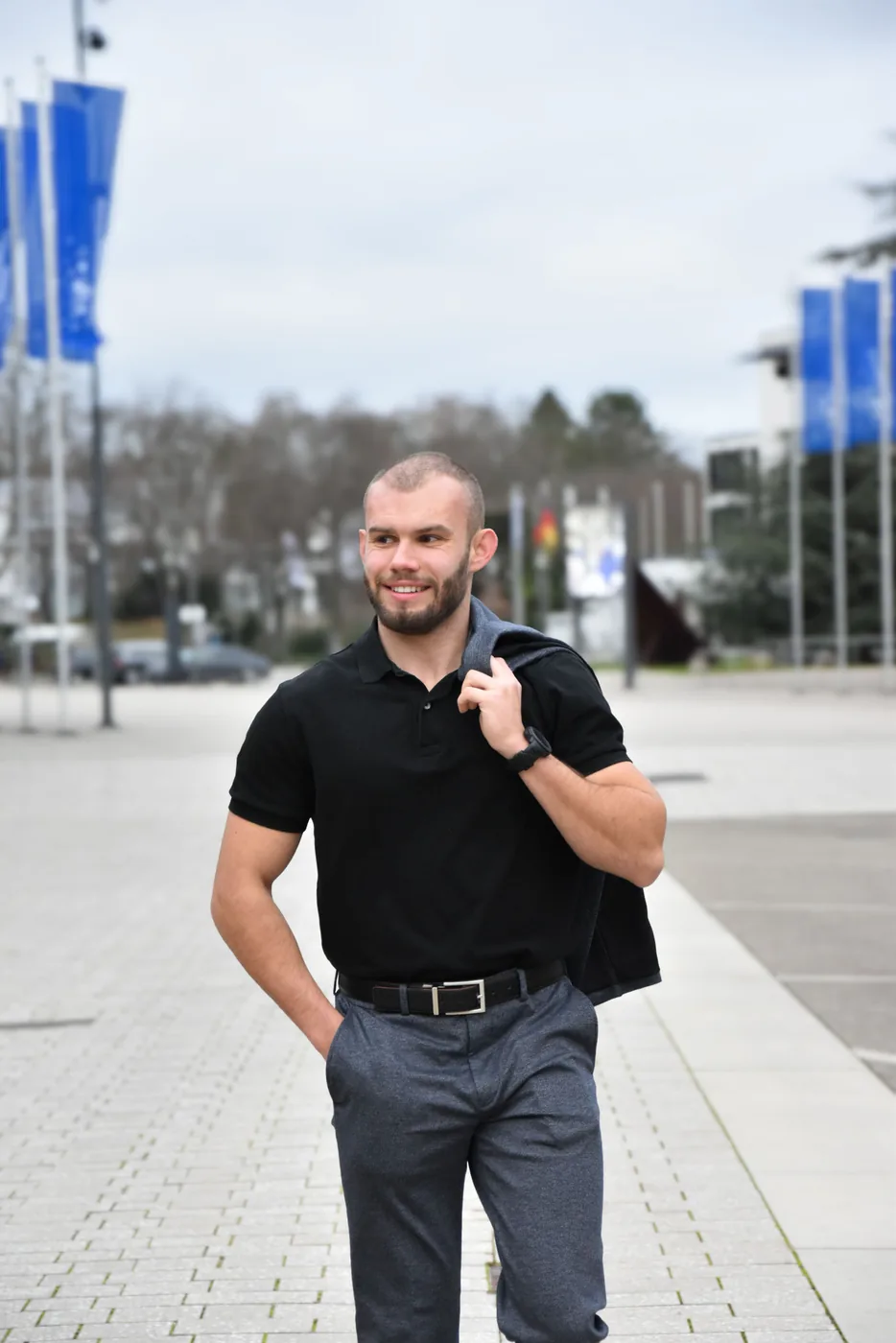 Mann im schwarzen Poloshirt bei einem Business-Shooting in der Stadt